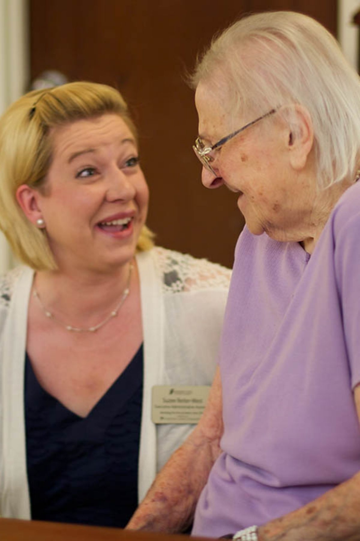 Someren Glen Senior Living Community in Centennial, CO - team member and older woman chatting portrait